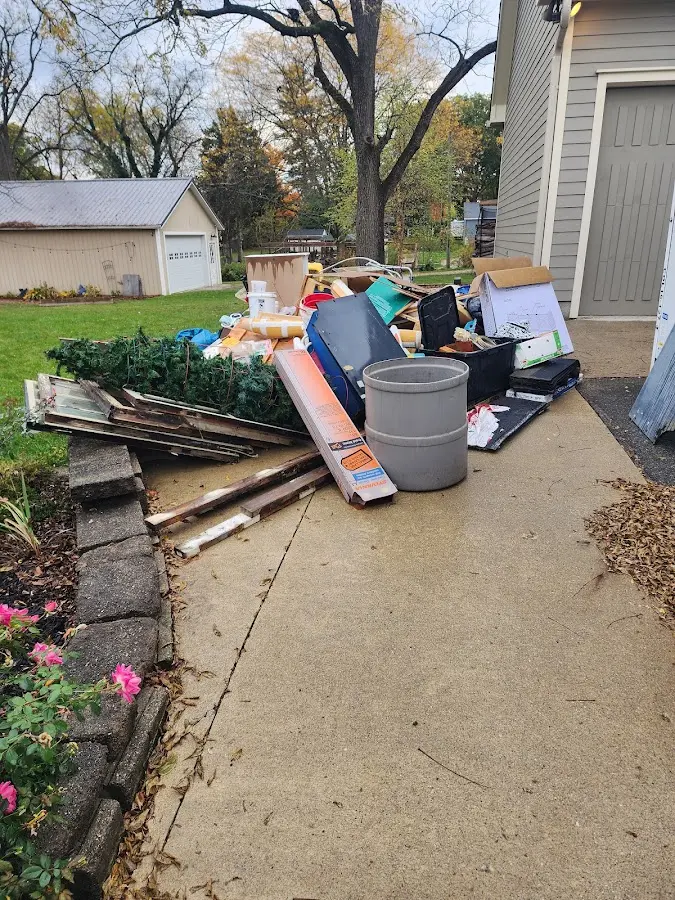 Dumpster being loaded with debris for Commercial Dumpster Rental in Lowell